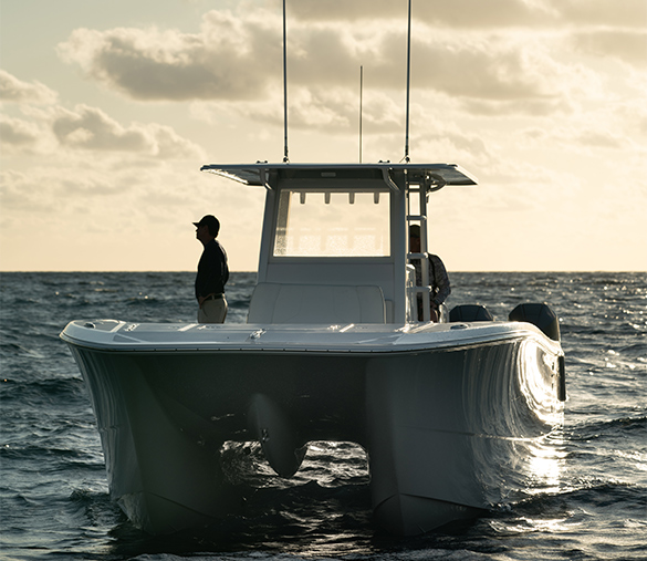 Man observing the waters in a spectacularly crafted 35 ft. Invincible catamaran for sale.